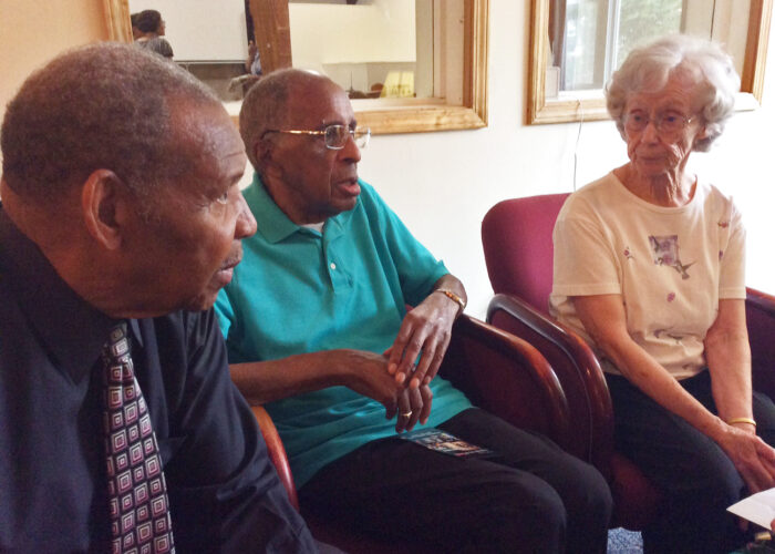 Left to right: Charles Marshall, Gerald Hughes, and Annabelle Hughes converse after the anniversary celebration. All three are original members of the church. Photo by Ann Jacobs.