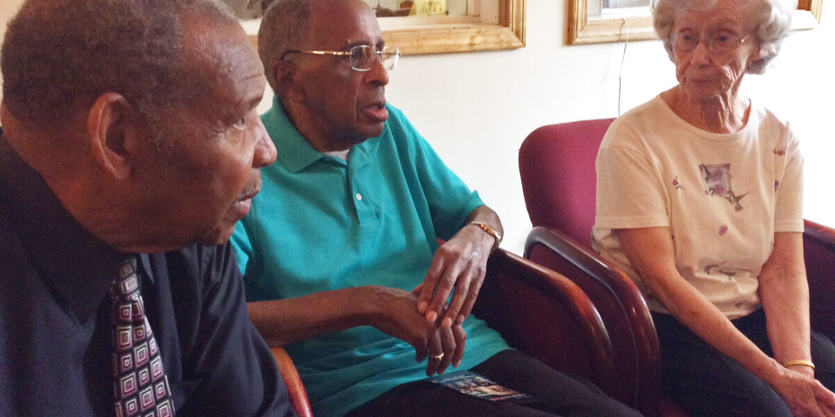 Left to right: Charles Marshall, Gerald Hughes, and Annabelle Hughes converse after the anniversary celebration. All three are original members of the church. Photo by Ann Jacobs.
