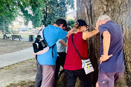 Praying at a lynching tree in Memphis. Issac Witmer, Rene Hostetter, and Art Stoltzfus