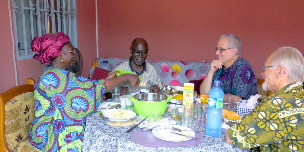 Claire and Siaka Traoré enjoy table fellowship with Bruce Yoder and Rod Hollinger-Janzen. Photographer: Lynda Hollinger-Janzen.