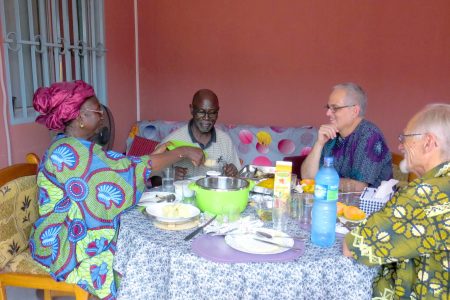 Claire and Siaka Traoré enjoy table fellowship with Bruce Yoder and Rod Hollinger-Janzen. Photographer: Lynda Hollinger-Janzen.