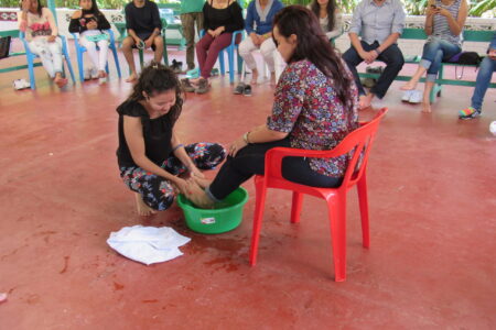 ​Lilibeth Guzman washes Andrea Castro Serrano's feet. Photo by Kelly Frey Martin.