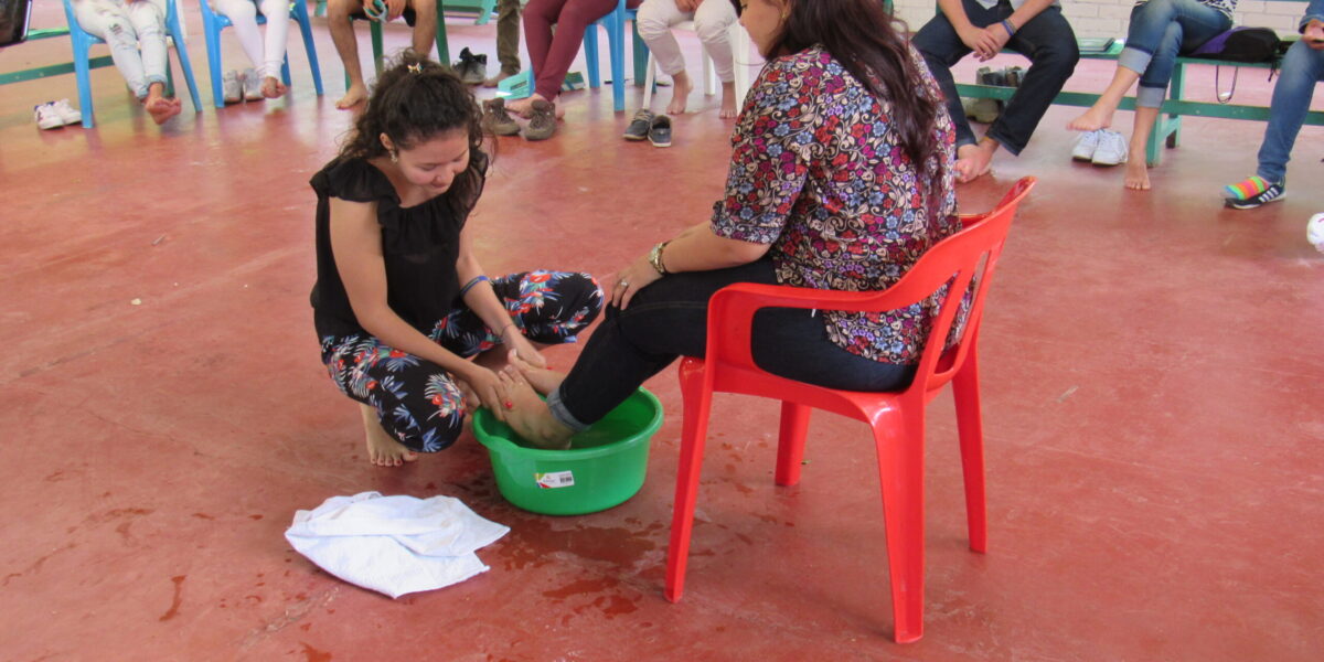 ​Lilibeth Guzman washes Andrea Castro Serrano's feet. Photo by Kelly Frey Martin.