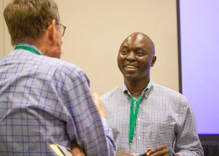 Nehemiah Chigoji (right) talks with a seminar attendee after co-leading the MennoCon21 seminar