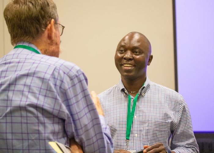 Nehemiah Chigoji (right) talks with a seminar attendee after co-leading the MennoCon21 seminar