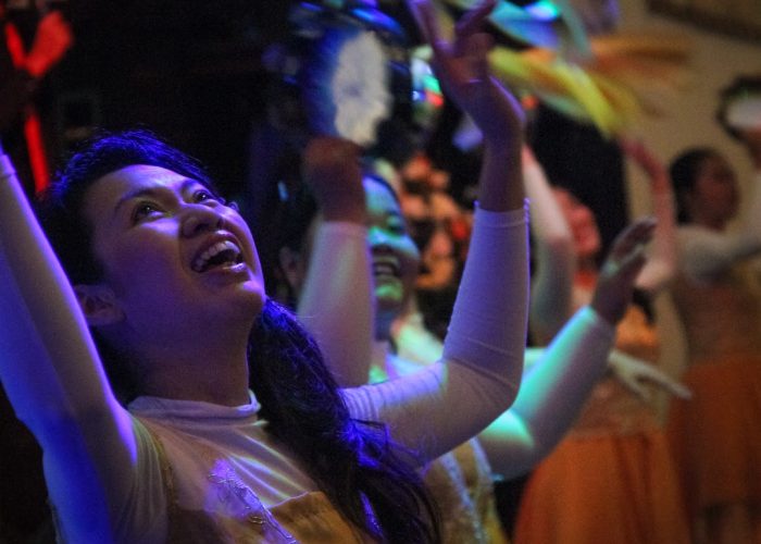 Analia Susanto, the treasurer of Maranatha church, dances for joy with others during worship at Maranatha Church in Indonesia.