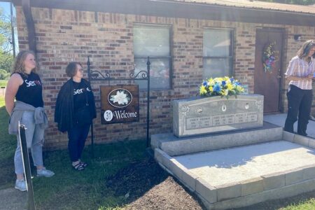 ​Participants in the Just Peace Pilgrimage civil rights tour stand near the marker commemorating Michael Schwerner