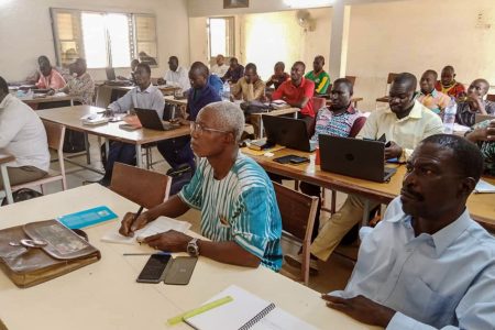 ​Sibiri Samuel Zongo and Sana Cabore take notes during Anicka Fast's Christianity in West Africa class at LOGOS University in Ouagadougou