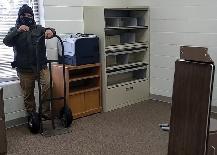 ​Naun Cerrato unloads office equipment for the office of La Posada at Sunnyside Mennonite Church in Elkhart
