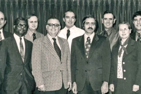 A 1973 photograph of the Mennonite Board of Missions. Back row, left to right: Louis Strite, Robert Summers, Jim Detweiler, James Mullet, Gerald Good. Front: Leamon Sowell, Sam Jantzen, Donald Yoder, Doris Kramer. Photo by Alvin Hostetler.