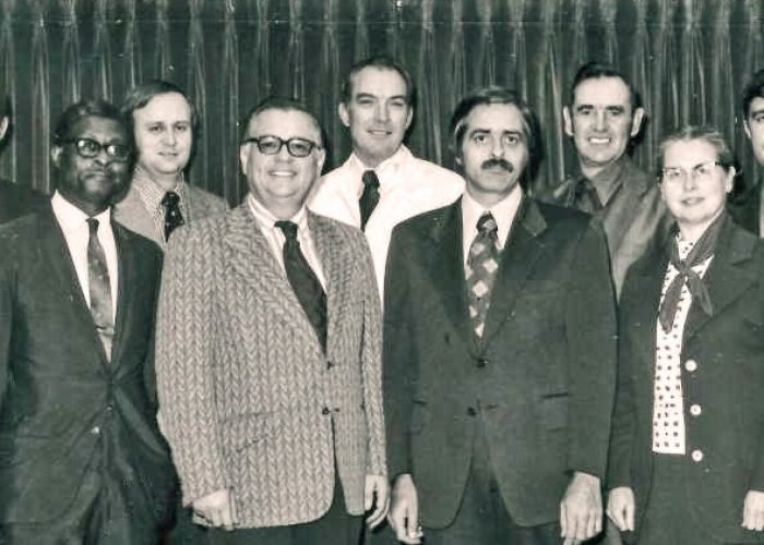A 1973 photograph of the Mennonite Board of Missions. Back row, left to right: Louis Strite, Robert Summers, Jim Detweiler, James Mullet, Gerald Good. Front: Leamon Sowell, Sam Jantzen, Donald Yoder, Doris Kramer. Photo by Alvin Hostetler.