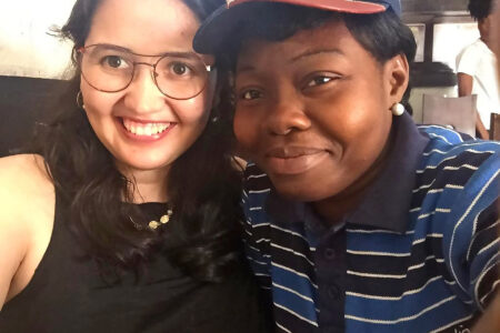 ​Diana Cruz and Mrs. Falola Apolline pause from their duties to share their love as teacher-learners. Photo by Diana Cruz.