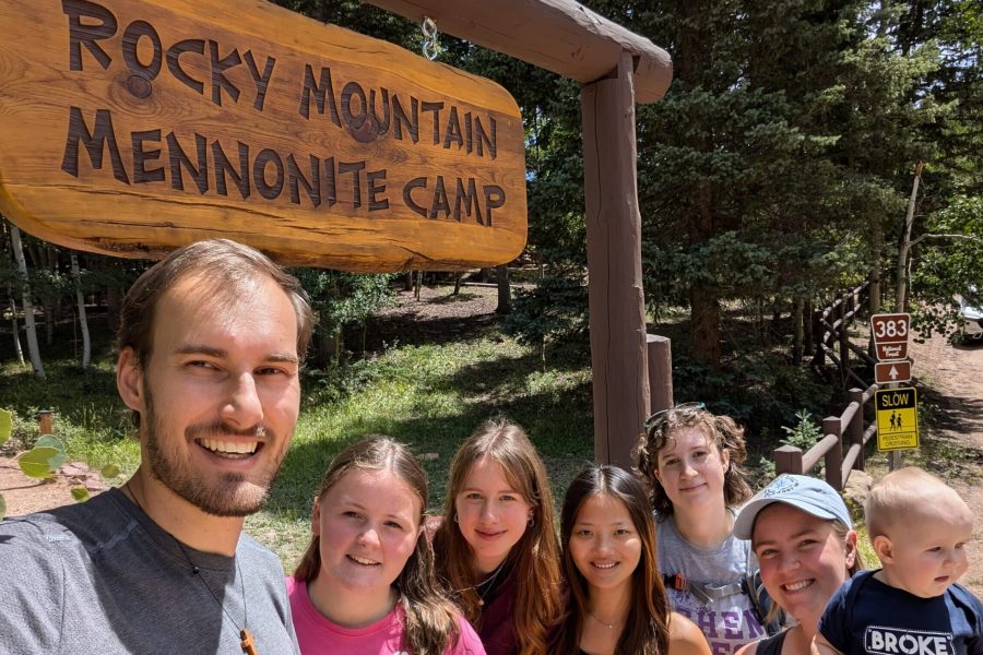 The 2024-25 Colorado Springs unit poses in front of the Rocky Mountain Mennonite Camp entrance sign. The camp is a Mission Network partner and placement site. From left: Christian Stoltzfus (unit leader), Elizabeth Daudey, Alea Sagert, Hannah Smith, Sadie Sherman, Leigha Stoltzfus (unit leader) with daughter Naomi. Photo by Christian Stoltzfus.