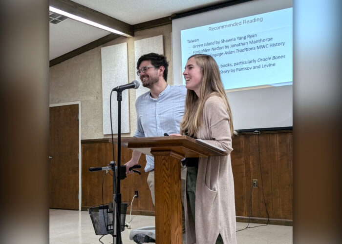 Caleb and Stephanie Schrock-Hurst present about their upcoming work in Taiwan to the crowd gathered at their fundraiser. Photo by Elizabeth Eby.