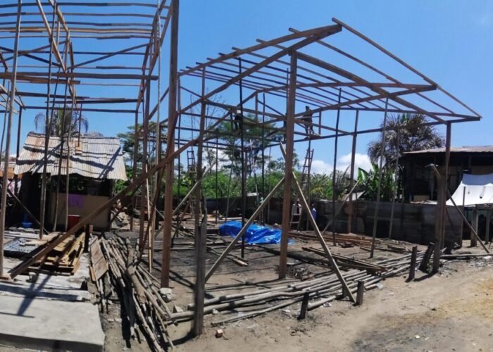 ​This panoramic view shows the five houses under construction and the street on Isla Iquitos