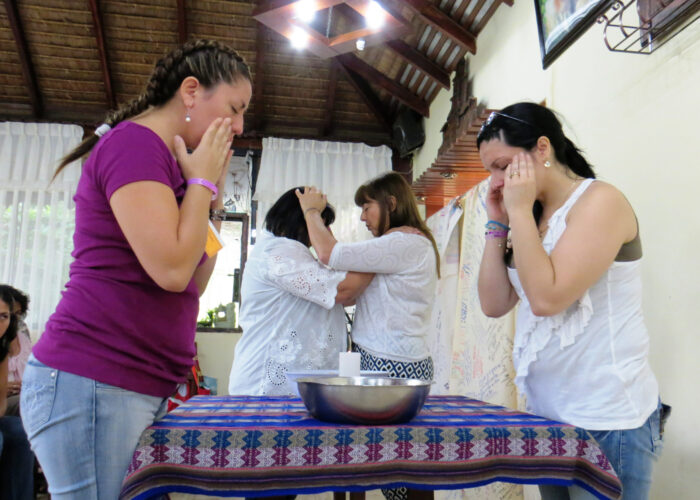 ​Marcia Soto and Alejandra Molina (foreground) and Estela Armoa and Aurora Rinaldi give and receive prayers and blessings at a Sister Care gathering in Bolivia. Photo provided. Click image for high resolution version.
