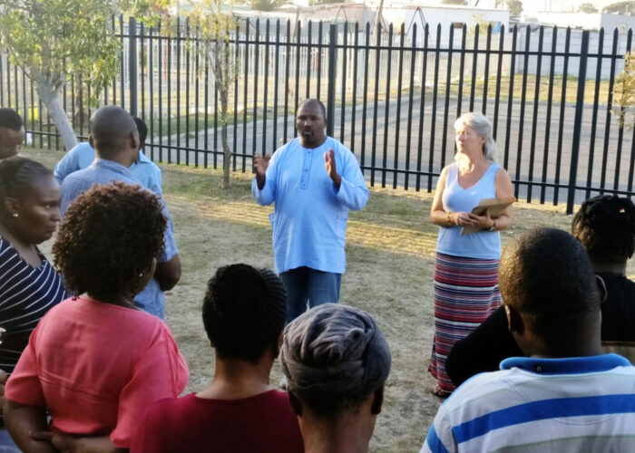 ​Oscar Siwali addresses Lwandle Leaders Community Conflict Transformation workshop participants with Kathryn Smith Derksen. Photo provided.