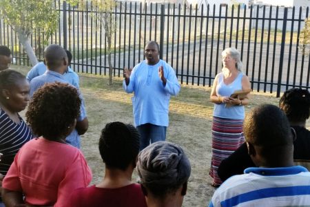 ​Oscar Siwali addresses Lwandle Leaders Community Conflict Transformation workshop participants with Kathryn Smith Derksen. Photo provided.