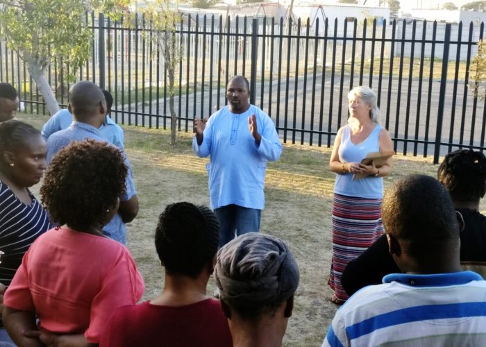 ​Oscar Siwali addresses Lwandle Leaders Community Conflict Transformation workshop participants with Kathryn Smith Derksen. Photo provided.