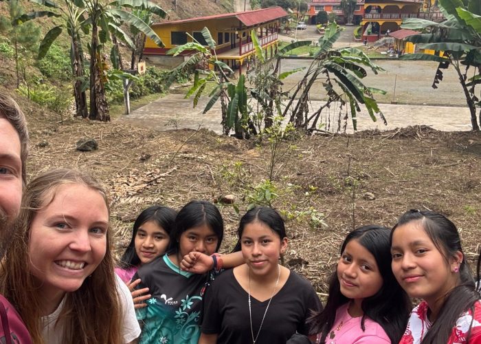The segundo basico students pose for a photo in the avocado grove on the Q’eqchi’ Bezaleel Mennonite Educational Center campus.