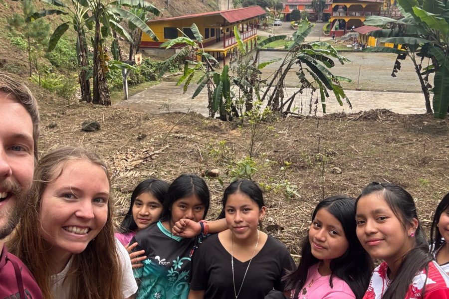 The segundo basico students pose for a photo in the avocado grove on the Q’eqchi’ Bezaleel Mennonite Educational Center campus.