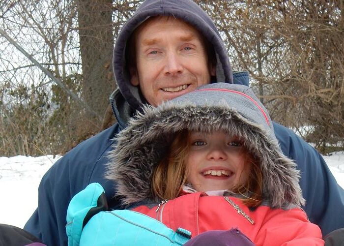 James Coyle sledding with his daughter Rebekah at Abshire Park in Goshen, Indiana. Photo by Cynthia Friesen Coyle.