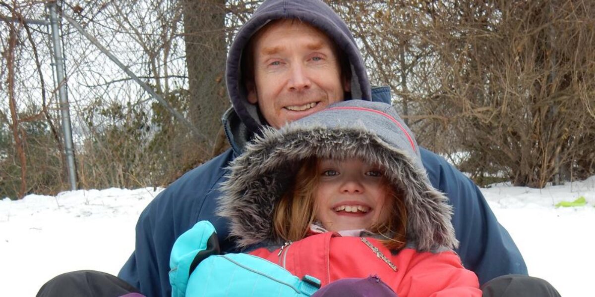 James Coyle sledding with his daughter Rebekah at Abshire Park in Goshen, Indiana. Photo by Cynthia Friesen Coyle.