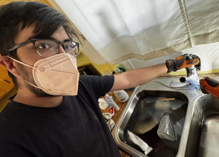 Juan Witmer, a participant with the 2025-26 Tucson MVS unit, works on a client's sink through his placement with CHRPA. Photo by Juan Witmer.