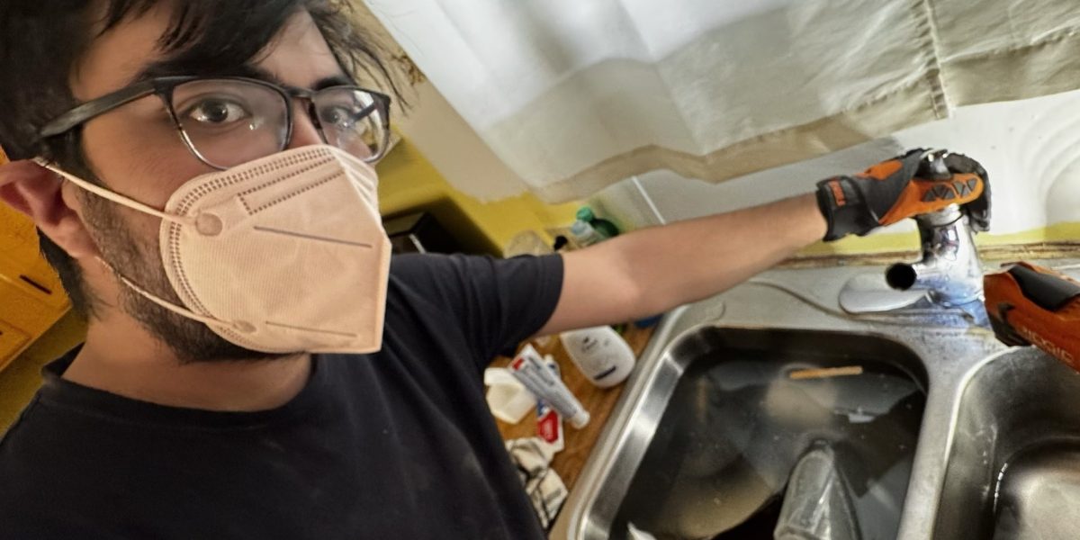 Juan Witmer, a participant with the 2025-26 Tucson MVS unit, works on a client's sink through his placement with CHRPA. Photo by Juan Witmer.