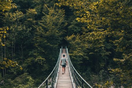 A person on a wooden footbridge.