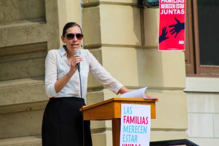 ​Lisa Koop addressing a Families Belong Together rally. Photo by Darrin Eichorn. 