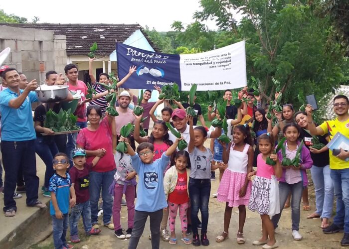 ​These youth and children hand out meals on the International Day of Peace as part of the Colombia Mennonite Church's celebration called "Pan y Paz" (Bread and Peace). This distribution of food symbolizes that justice making (everyone needs something to eat) is integral to peace-making. Photo by Kelly Frey Martin.